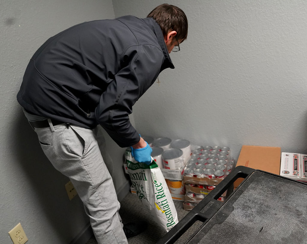 Curtis Soulsey, a staff member at Woodhaven, places the food donations in an office